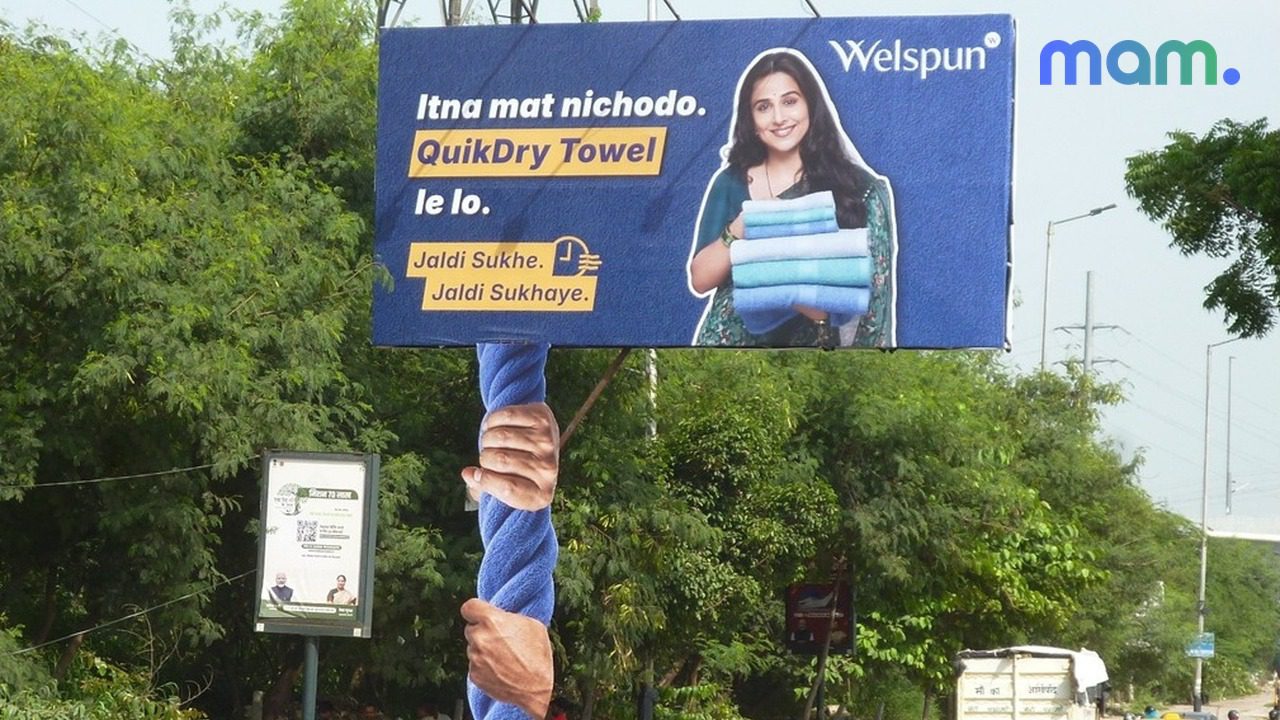 Welspun QuikDry monsoon OOH — towel texture on city buses Delhi Mumbai Bengaluru — mam mark